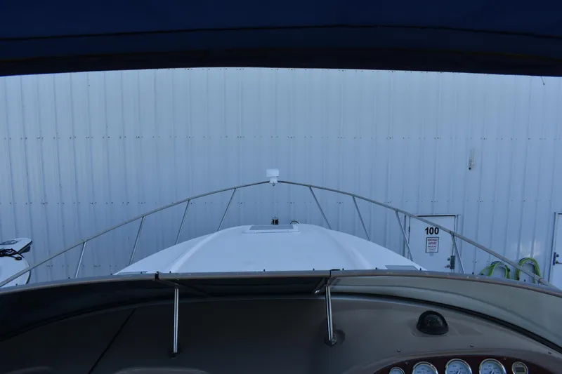 Slide: The Image of View from the helm of a 2003 Bayliner 305 boat docked in a marina. - 22