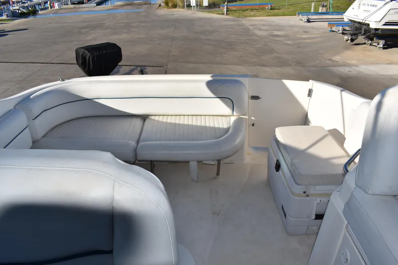 Slide: The Image of 2003 Bayliner 305 boat interior with white seating and storage compartments. - 23