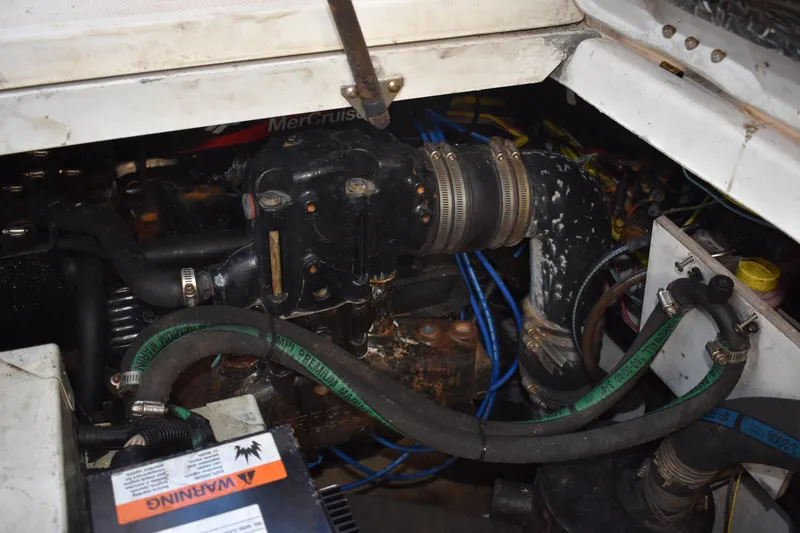Slide: The Image of 2003 Bayliner 305 engine compartment with visible hoses and components. - 26