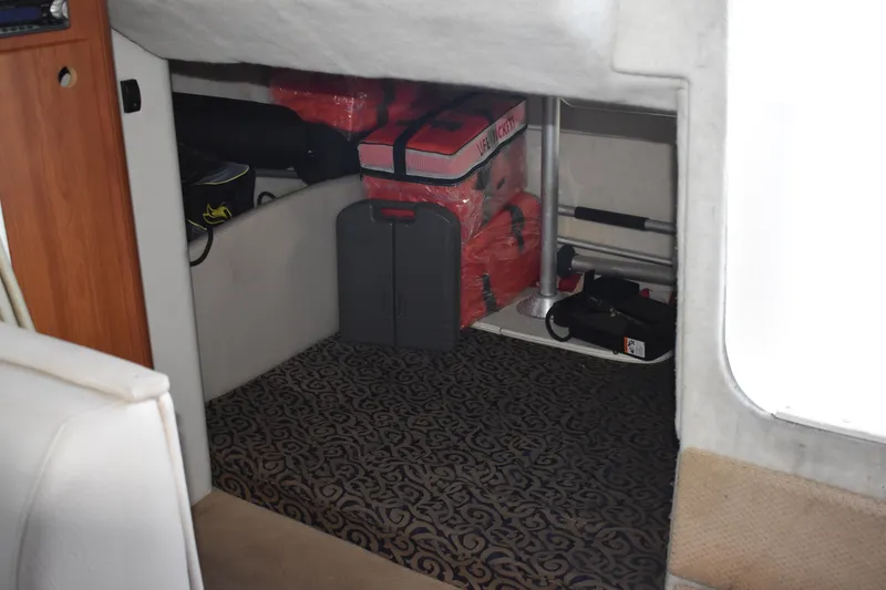 Slide: The Image of Interior storage area of a 2003 Bayliner 305 boat with various equipment. - 28