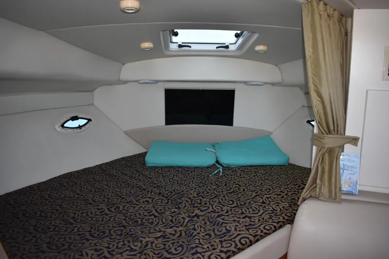 Slide: The Image of 2003 Bayliner 305 boat interior cabin with bed and skylight. - 32