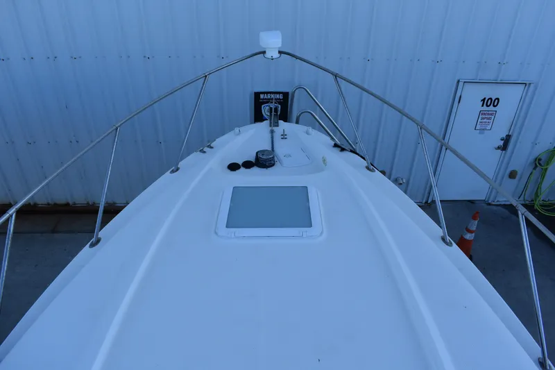 Slide: The Image of 2003 Bayliner 305 boat deck with railing and hatch. - 36