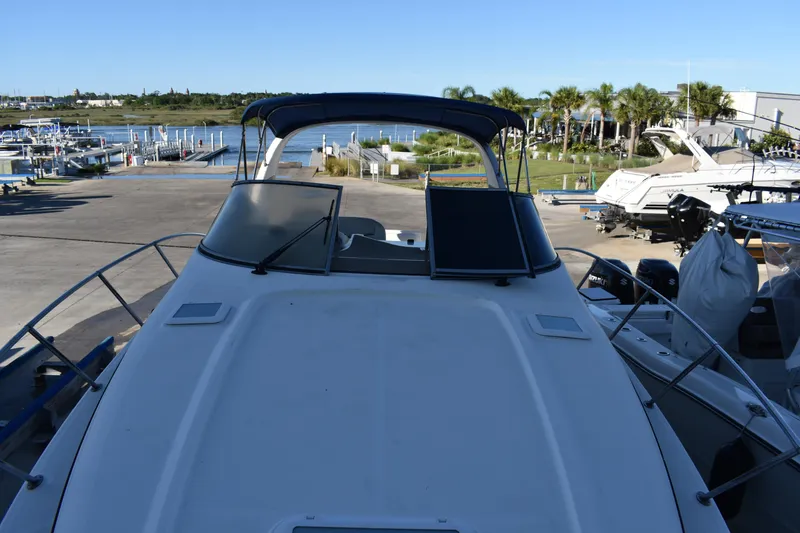 Slide: The Image of 2003 Bayliner 305 boat docked at a marina. - 37