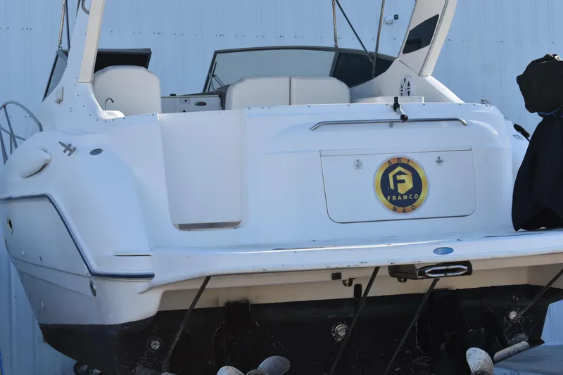Slide: The Image of 2003 Bayliner 305 boat stern view in dry dock. - 40
