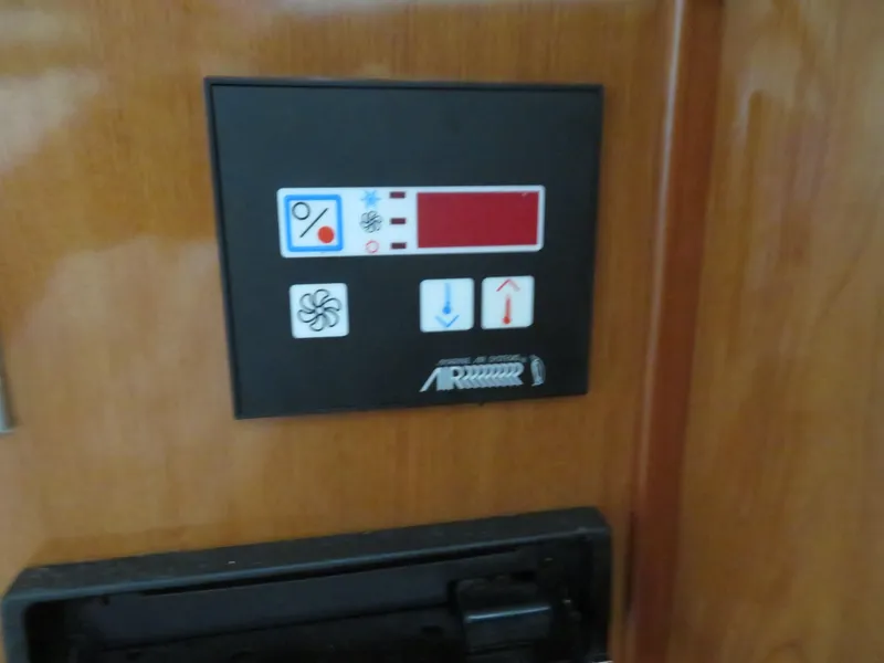 Slide: The Image of Control panel on 2005 Maxum 3300 SE boat, featuring fan and temperature icons. - 14