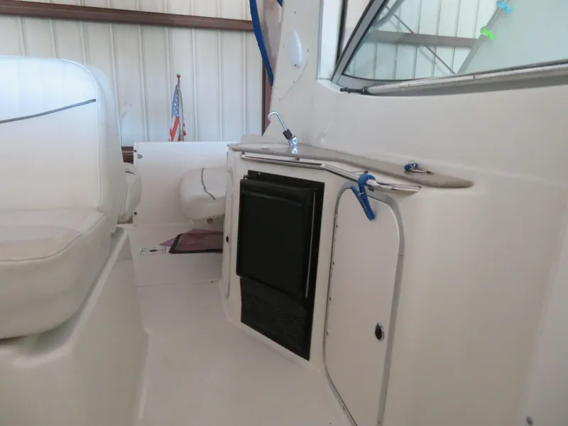 Slide: The Image of 2005 Maxum 3300 SE boat interior with kitchenette and seating area. - 15