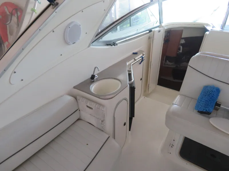Slide: The Image of 2005 Maxum 3300 SE boat interior with seating, sink, and window view. - 18