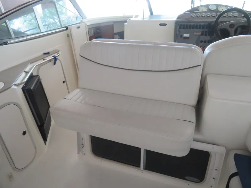 Slide: The Image of 2005 Maxum 3300 SE boat interior with white seating and control panel. - 19