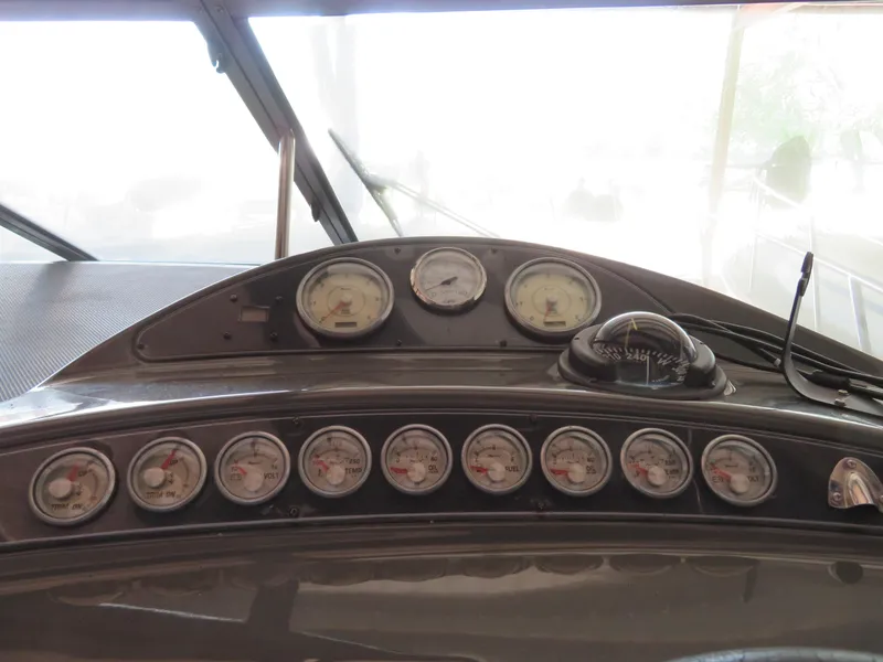 Slide: The Image of Dashboard of a 2005 Maxum 3300 SE boat with multiple gauges and controls. - 23