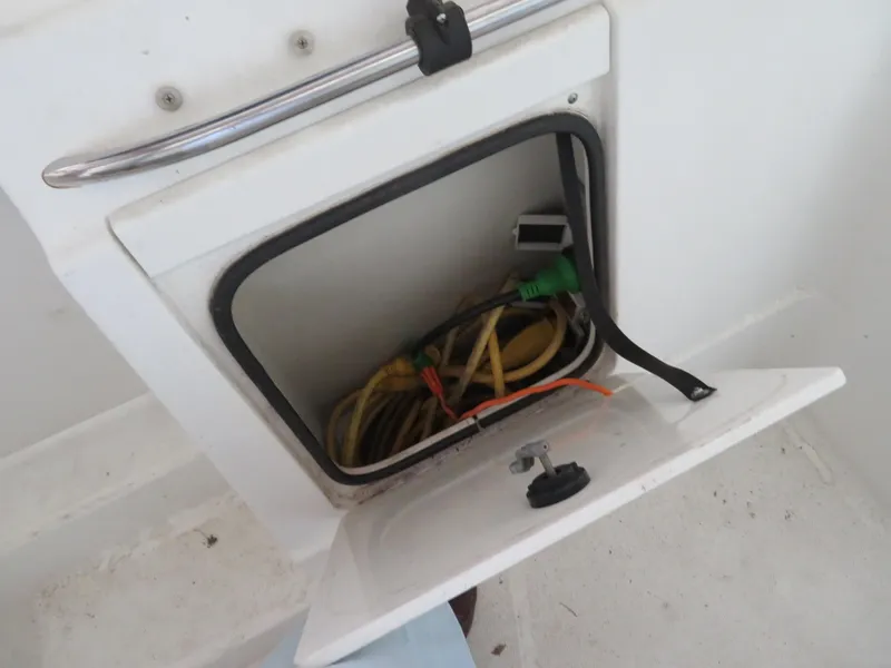 Slide: The Image of Storage compartment with cables on a 2005 Maxum 3300 SE boat. - 24