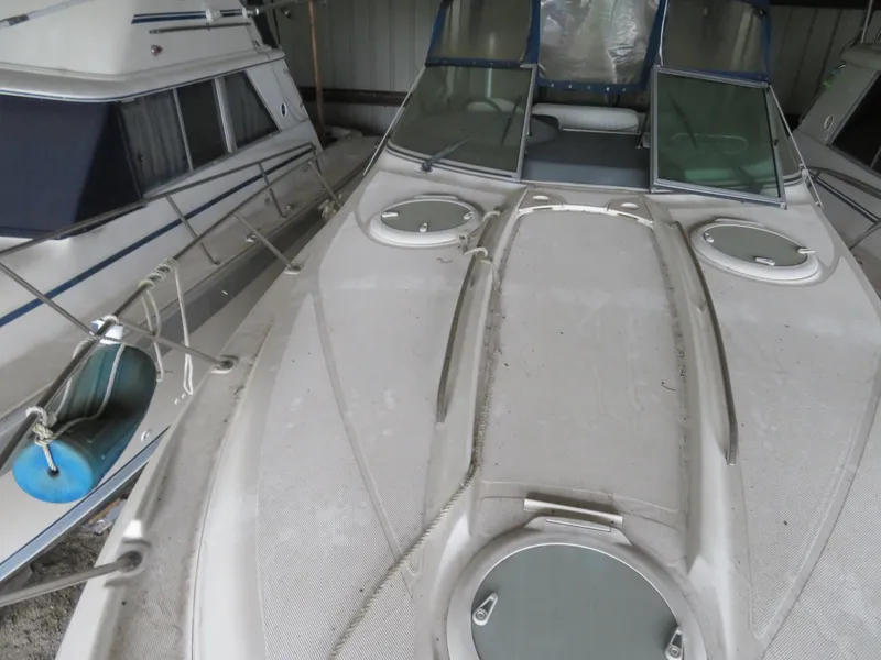 Slide: The Image of 2005 Maxum 3300 SE boat docked in a marina, showing deck and cabin area. - 30