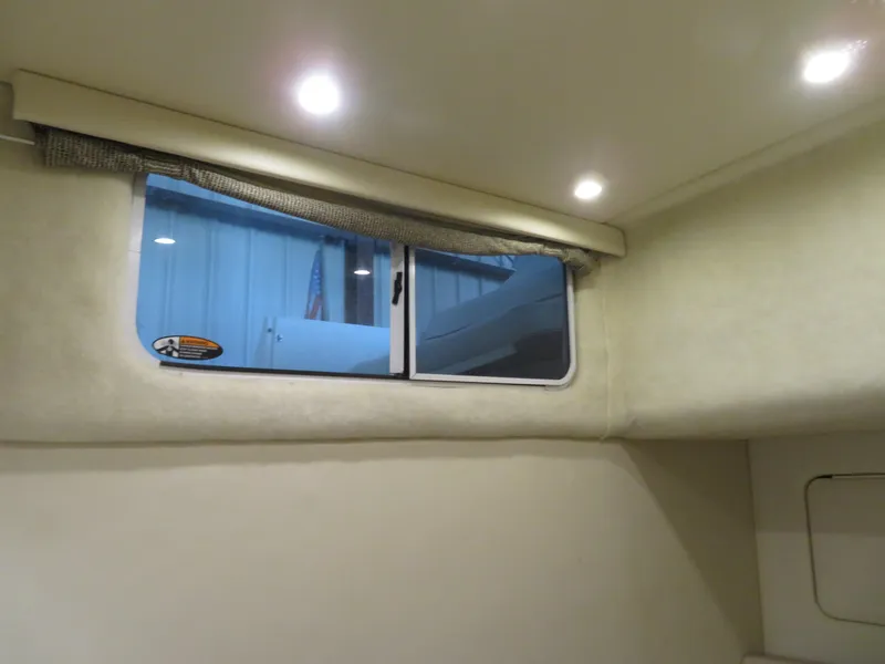 Slide: The Image of 2005 Maxum 3300 SE cabin interior with window and recessed lighting. - 6