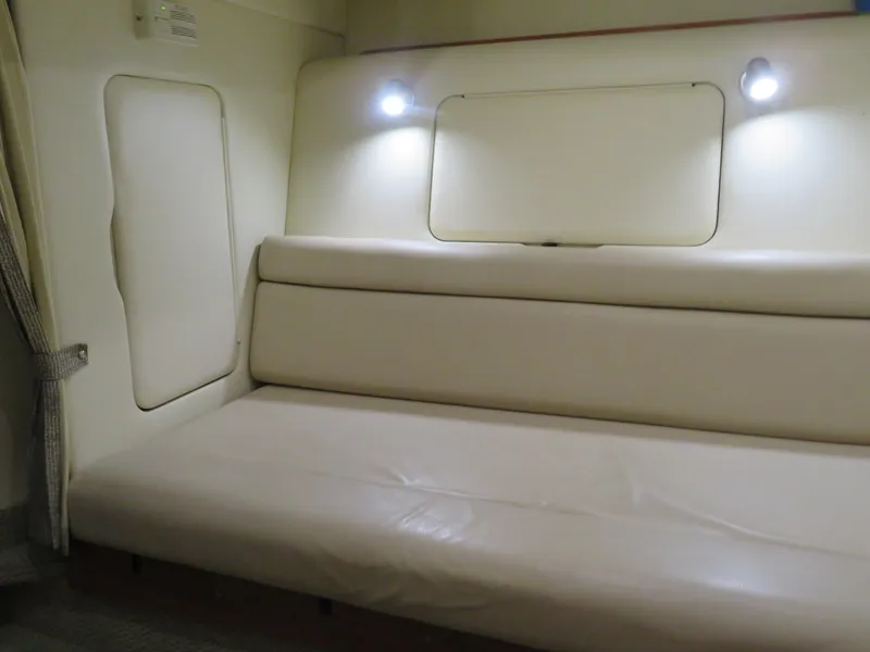 Slide: The Image of 2005 Maxum 3300 SE interior with beige seating and ambient lighting. - 7