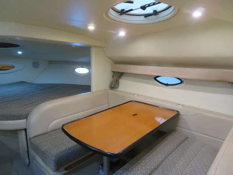 Slide: The Image of 2005 Maxum 3300 SE cabin interior with dining area and sleeping quarters. - 9