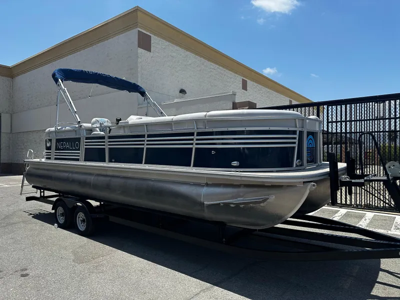 The Image of 2022 Nepallo CW24-ST24QL pontoon boat on a trailer in a parking lot. - 0
