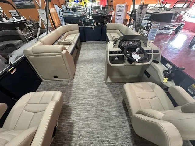 Slide: The Image of 2024 Godfrey Sweetwater 2286 SB GTP pontoon boat interior with beige seating and modern helm. - 18
