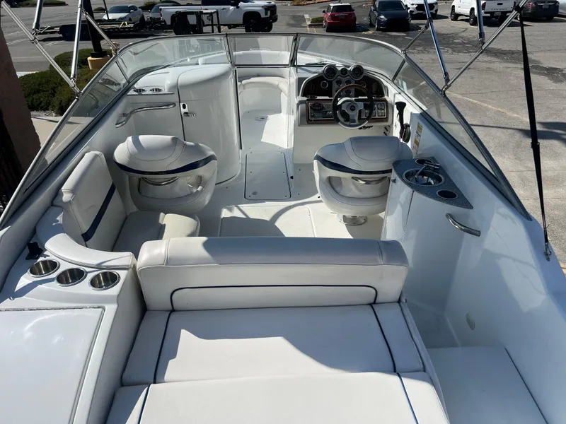 Slide: The Image of 2006 Formula 240 Bowrider boat interior with white seating and dashboard. - 11