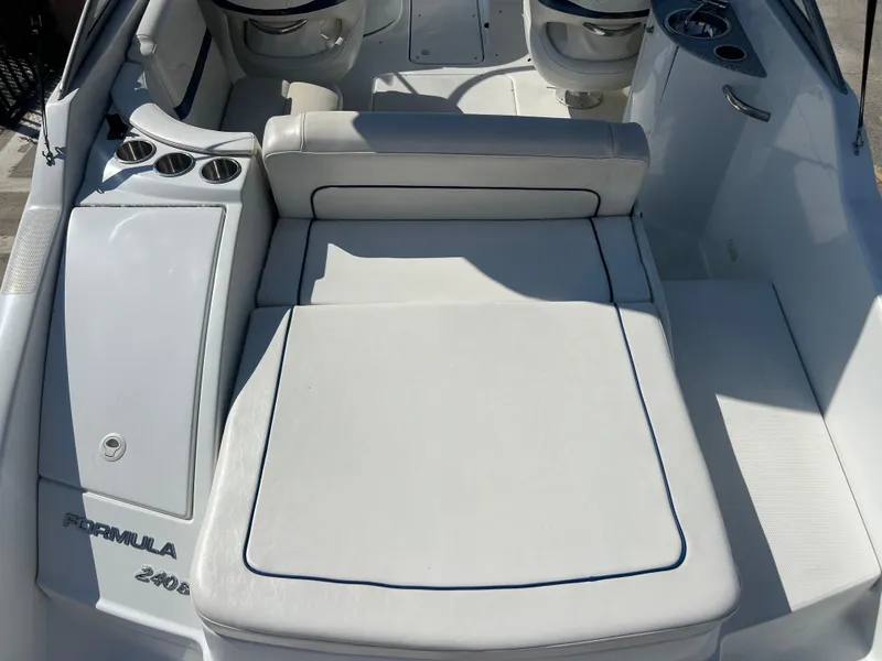 Slide: The Image of 2006 Formula 240 Bowrider boat interior with white seating and cup holders. - 12