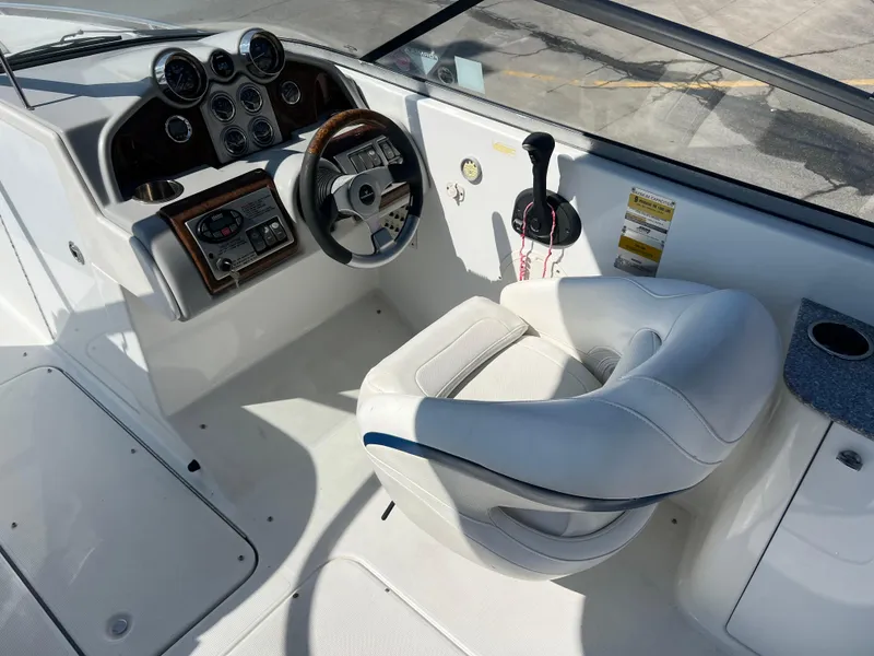 Slide: The Image of 2006 Formula 240 Bowrider boat cockpit with steering wheel and control panel. - 14