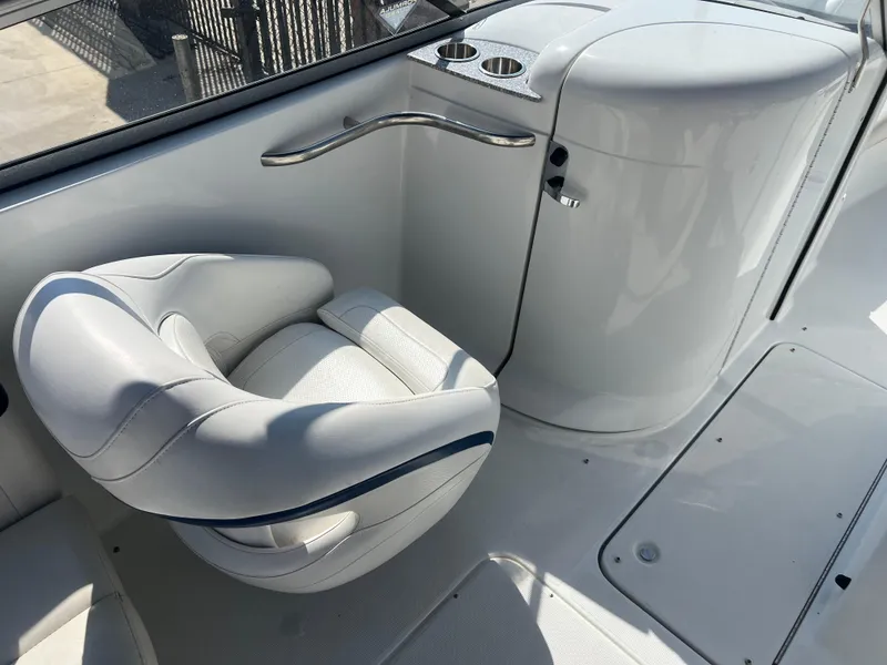 Slide: The Image of 2006 Formula 240 Bowrider boat interior with white seating and cup holders. - 16
