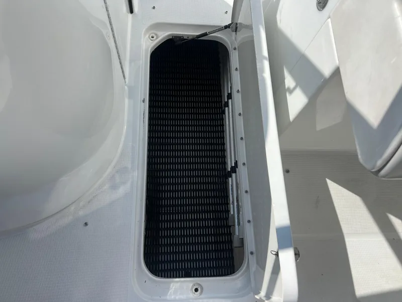 Slide: The Image of Open storage compartment on a 2006 Formula 240 Bowrider boat. - 18