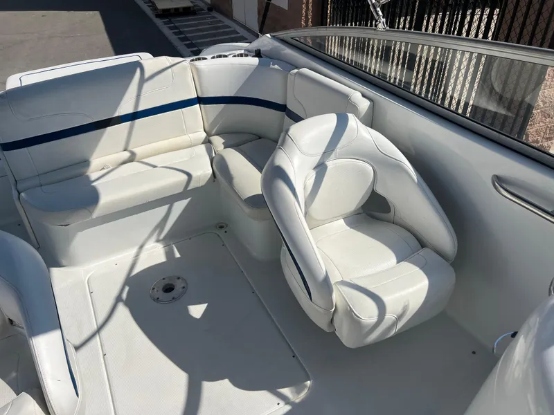 Slide: The Image of 2006 Formula 240 Bowrider boat interior with white seating and blue accents. - 22
