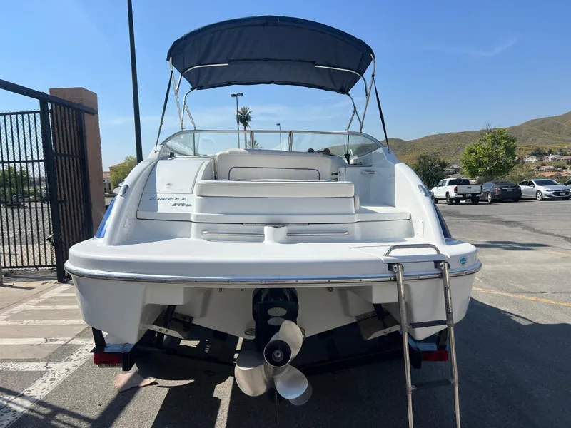 Slide: The Image of 2006 Formula 240 Bowrider boat with canopy, rear view in parking lot. - 4