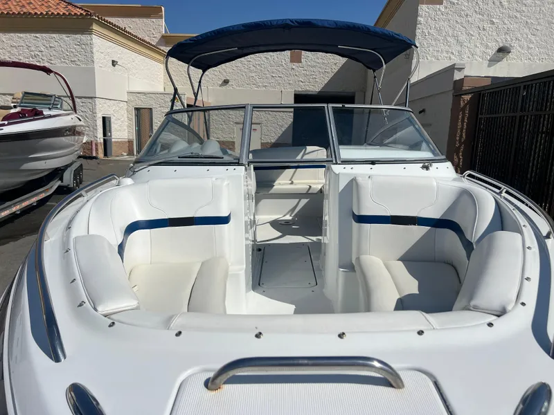 Slide: The Image of 2006 Formula 240 Bowrider with white and blue interior, docked outdoors. - 6