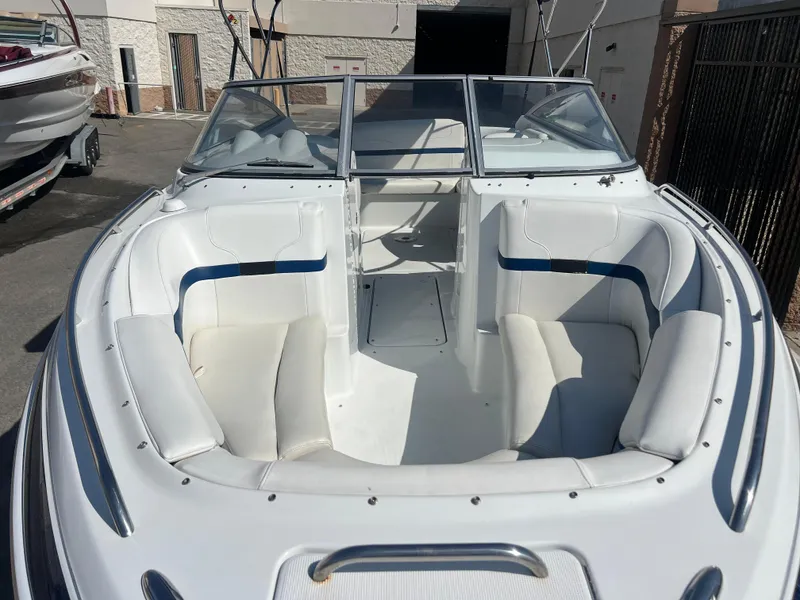 Slide: The Image of 2006 Formula 240 Bowrider boat with white seating and open bow area. - 7