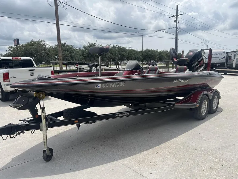 Slide: The Image of 2016 Stratos 201 XL Evolution boat on a trailer in a parking lot. - 7
