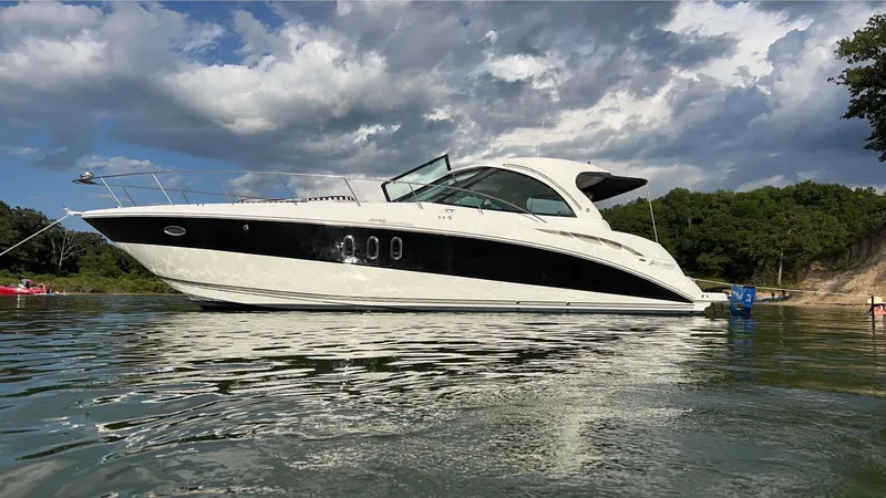 The Image of 2009 Cruisers 390 Sportcoupe yacht on calm water under cloudy sky. - 0