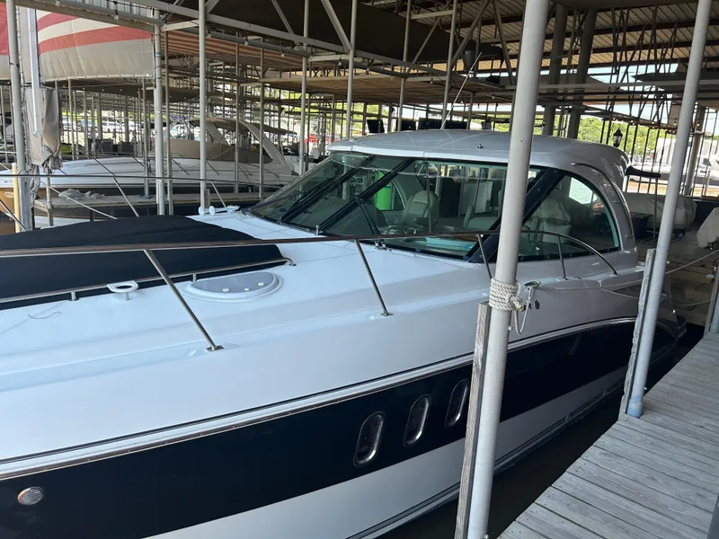 Slide: The Image of 2009 Cruisers 390 Sport Coupe docked in a marina, showcasing sleek design and modern features. - 13