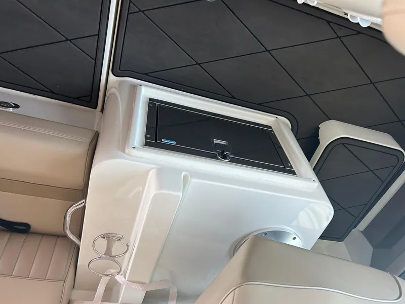 Slide: The Image of Interior of 2009 Cruisers 390 Sportcoupe with beige seating and built-in storage. - 14