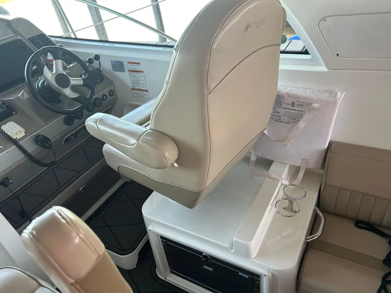 Slide: The Image of 2009 Cruisers 390 Sportcoupe helm with beige seating and modern controls. - 15