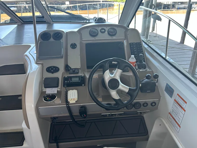 Slide: The Image of 2009 Cruisers 390 Sportcoupe helm with steering wheel and navigation controls. - 16