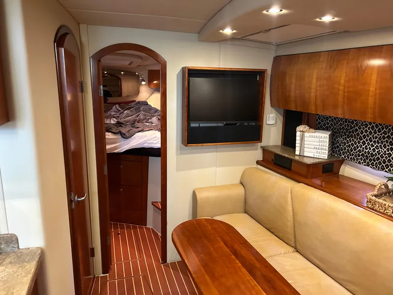 Slide: The Image of 2009 Cruisers 390 Sportcoupe interior with cozy seating, wood accents, and a flat-screen TV. - 21