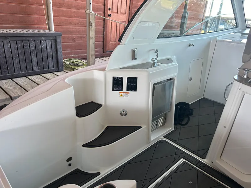 Slide: The Image of 2009 Cruisers 390 Sportcoupe interior with sink and mini fridge, docked at marina. - 12