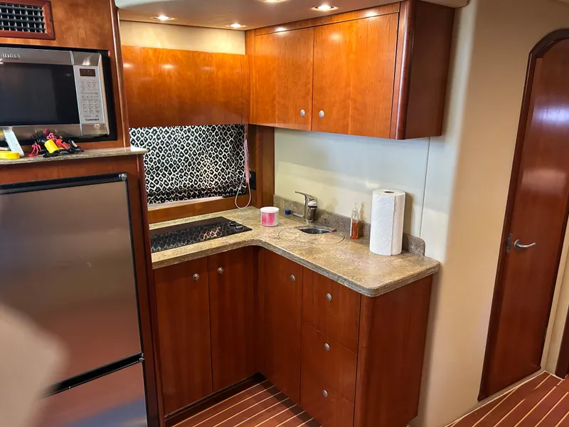 Slide: The Image of 2009 Cruisers 390 Sportcoupe kitchen with wood cabinets, countertop, and modern appliances. - 20