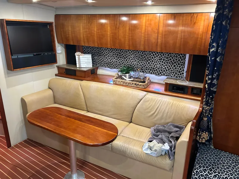 Slide: The Image of 2009 Cruisers 390 Sportcoupe interior with beige sofa, wooden table, and patterned decor. - 22