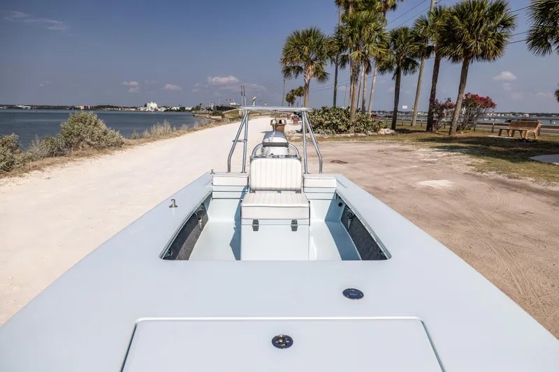 Slide: The Image of 2008 Hell's Bay Waterman 16 boat on a sandy shore with palm trees. - 18