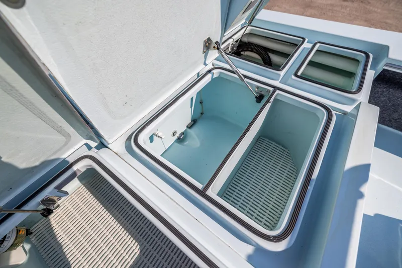 Slide: The Image of Open storage compartments on a 2008 Hell's Bay Waterman 16 boat. - 22