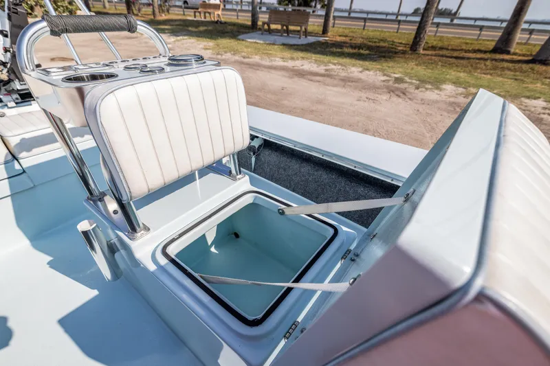 Slide: The Image of 2008 Hell's Bay Waterman 16 boat with open storage compartment and cushioned seat. - 30