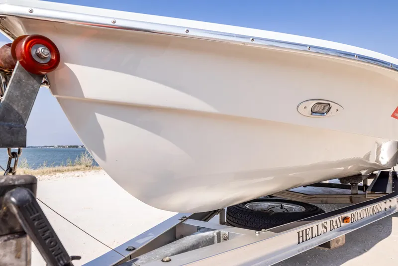 Slide: The Image of 2008 Hell's Bay Waterman 16 boat on trailer near water. - 37