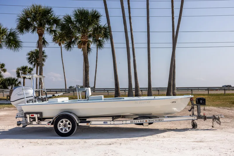 Slide: The Image of 2008 Hell's Bay Waterman 16 boat on trailer with palm trees in the background. - 5
