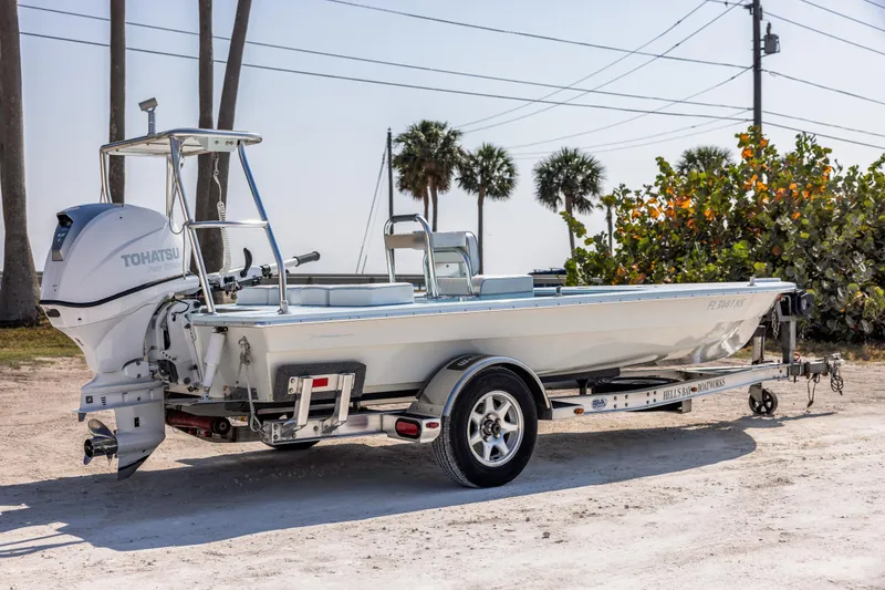 Slide: The Image of 2008 Hell's Bay Waterman 16 boat on a trailer with Tohatsu outboard motor. - 6
