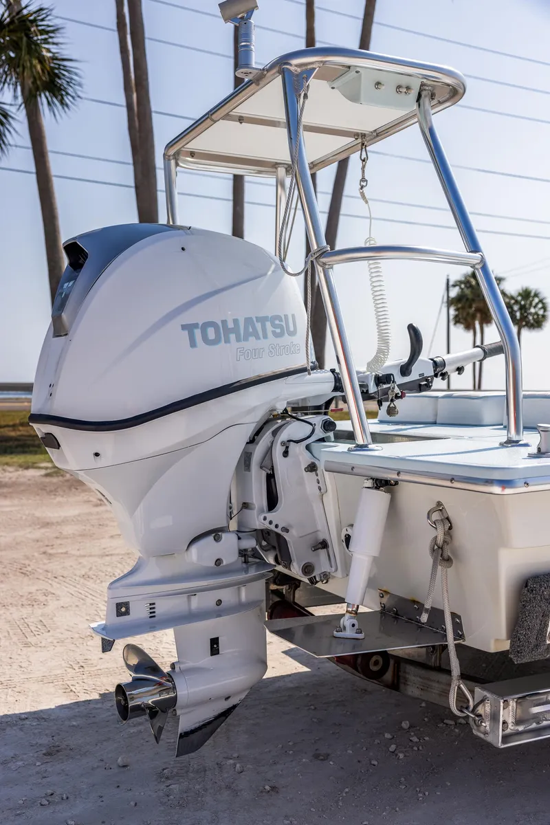 Slide: The Image of 2008 Hell's Bay Waterman 16 with Tohatsu outboard motor, docked on a sunny day. - 7