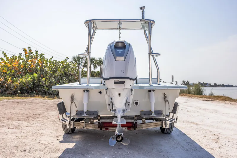 Slide: The Image of 2008 Hell's Bay Waterman 16 boat on trailer, rear view near waterfront. - 8