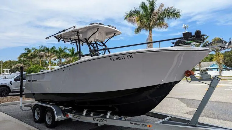 The Image of 2023 Sea Born SX239 Offshore boat on trailer, parked near palm trees. - 0