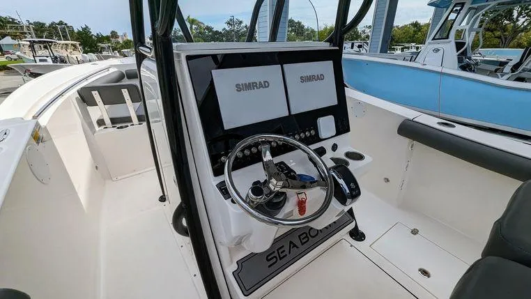 Slide: The Image of 2023 Sea Born SX239 Offshore boat cockpit with dual Simrad displays. - 10