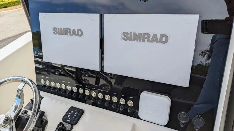 Slide: The Image of 2023 Sea Born SX239 Offshore boat dashboard with dual Simrad displays. - 11